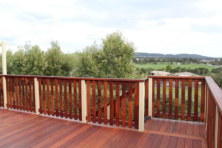 Immaculately Polished and Stained Hardwood Deck and Railing with Hills, Paddocks and Trees in Backdrop