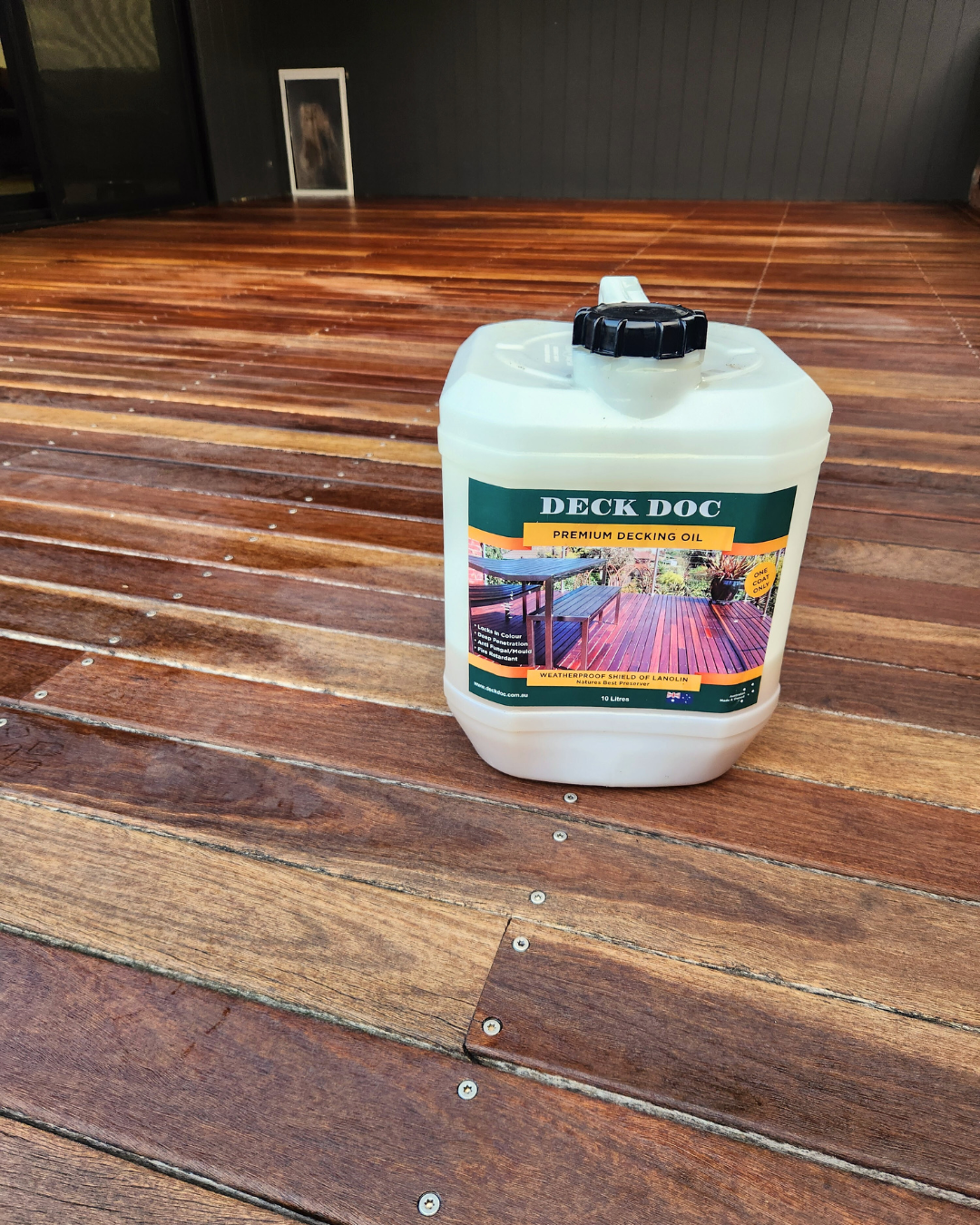 Container of Deck Doc premium decking oil on a wooden surface